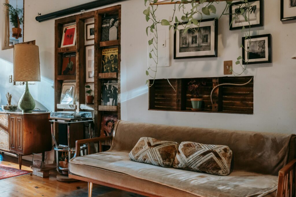 Cozy vintage living room with 1970s-style furniture, record storage, and layered retro decor